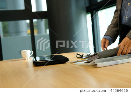 woman holding notebook at office after finishing work woman holding notebook at office after finishing work 44364636