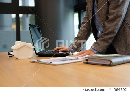 real estate agent realtor with house model computer & contract agreement. buying selling renting property 44364702
