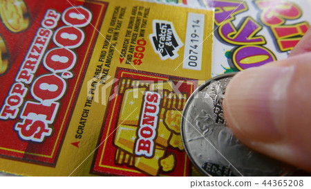 Woman scratching lottery ticket. Woman scratching lottery ticket. 44365208