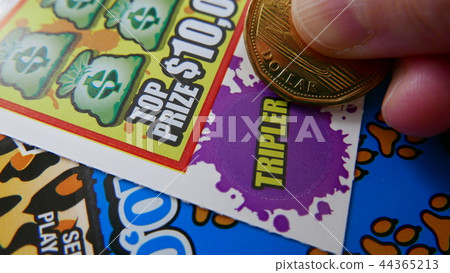 Woman scratching lottery ticket. Woman scratching lottery ticket. 44365213