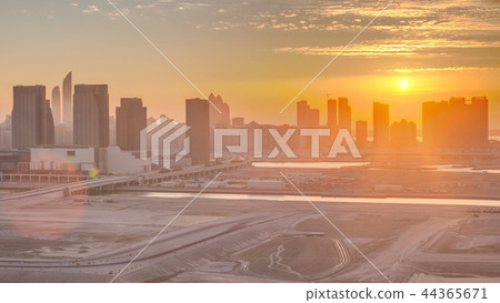 Buildings on Al Reem island in Abu Dhabi at sunset timelapse from above. 44365671