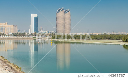 View of skyscrapers skyline with Al Bahr towers in Abu Dhabi timelapse. United Arab Emirates 44365767
