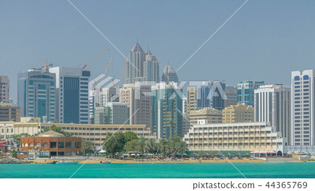 Modern buildings in Abu Dhabi skyline timelapse with mall and beach. 44365769