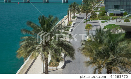 Walkway in Abu Dhabi timelapse with palms 44365770