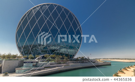 Circular skyscraper Aldar Headquarters Building timelapse in Abu Dhabi, UAE. Circular skyscraper Aldar Headquarters Building timelapse in Abu Dhabi, UAE. 44365836