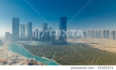 Buildings on Al Reem island in Abu Dhabi timelapse from above. 44365874