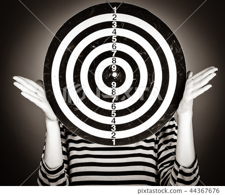 Girl with dartboard in place of head. Girl with dartboard in place of head. 44367676