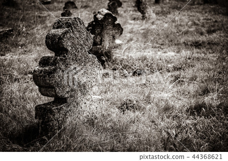 christian cross on an old shattered and cracked grave 44368621