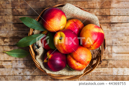 Peaches on a rustic wooden background Peaches on a rustic wooden background 44369755