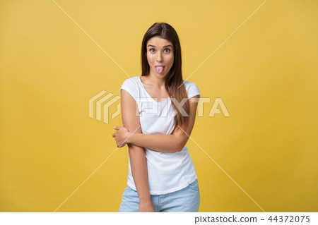 Portrait of a playful young woman with her tongue out. Portrait of a playful young woman with her tongue out. 44372075