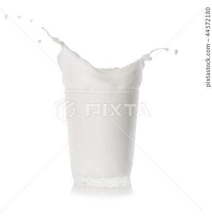 Splash of fresh cold milk in a glass, transparent glass 44372180