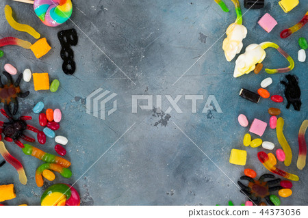 Colorful halloween candies on stone 44373036