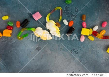 Colorful halloween candies on stone 44373039
