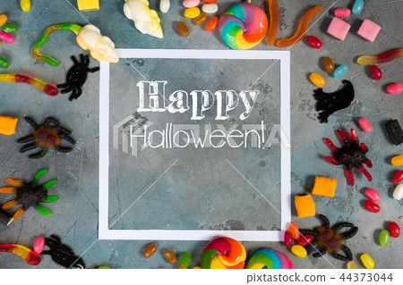 Colorful halloween candies on stone 44373044