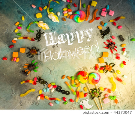 Colorful halloween candies on stone 44373047