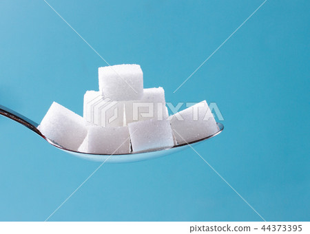 Sugar on blue background Sugar on blue background 44373395