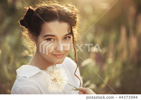 Beautiful carefree woman in fields being happy outdoors Beautiful carefree woman in fields being happy outdoors 44373994