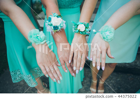 women's hands with green bracelets bridesmaids 44375022
