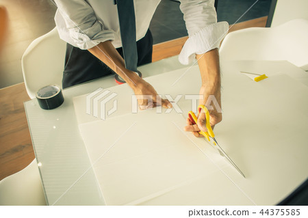 Asian man paper cutting with scissors 44375585