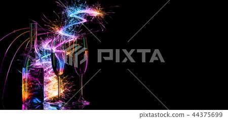 Bottle and glasses with champagne in the light of colored Bengal 44375699