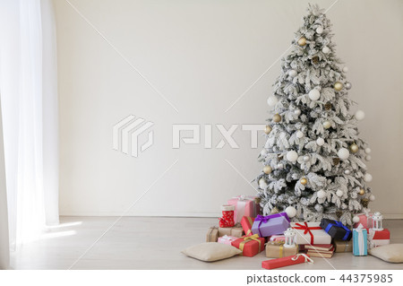 the Interior of the white room with a Christmas tree and Christmas gifts the Interior of the white room with a Christmas tree and Christmas gifts 44375985