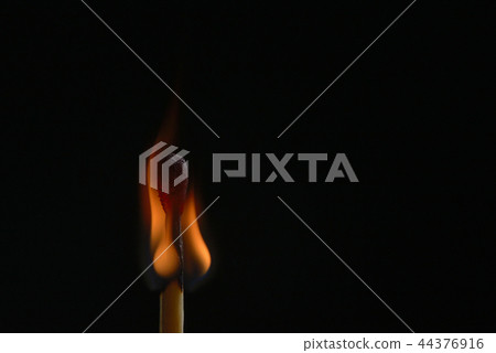 Burning match on black background 44376916