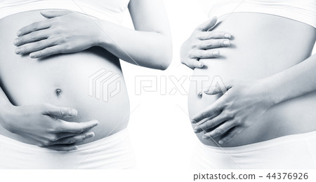 Young pregnant woman caress belly. 44376926