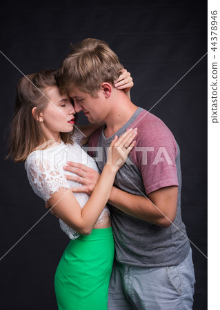 Lovers kissing each other on black background 44378946