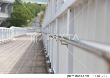 A handrail of a pedestrian overpass A handrail of a pedestrian overpass 44381217
