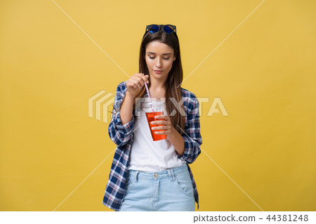 Young woman holding and drinking cold drink beverage in casual clothes. pretty girl smiling happy 44381248