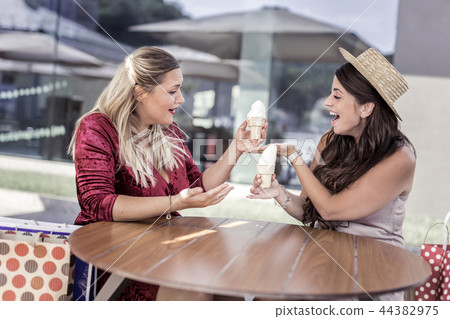 Happy nice women holding ice cream cones 44382975
