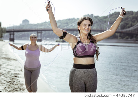 Happy nice women holding skipping ropes in their hands 44383747
