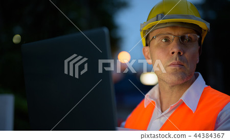 Mature man construction worker at the construction site in the c Mature man construction worker at the construction site in the c 44384367