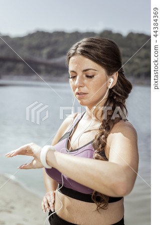 Nice pleasant woman standing in the headphones Nice pleasant woman standing in the headphones 44384369