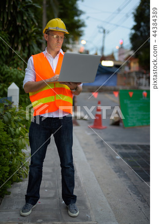 Mature man construction worker at the construction site in the c 44384389