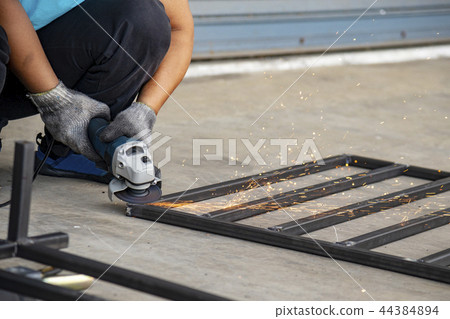 Worker use hand grinder machine. 44384894