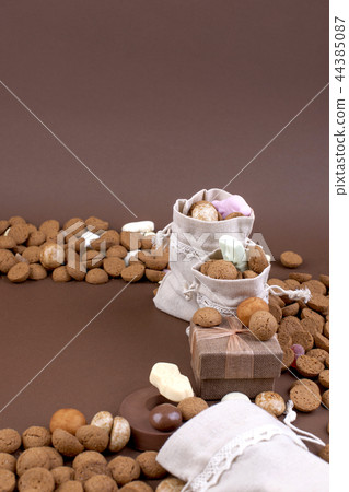 Dutch holiday Sinterklaas background with pepernoten.Traditional sweets and gifts for children for Dutch holiday Sinterklaas background with pepernoten.Traditional sweets and gifts for children for 44385087