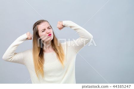 Powerful young woman in success pose 44385247