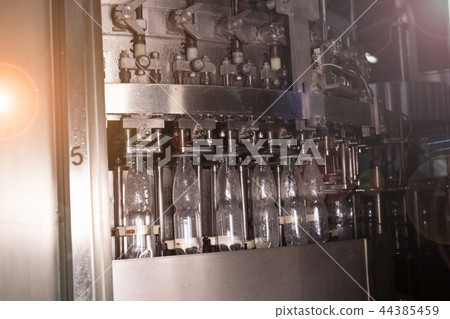 Factory and production concept - conveyor for bottling water from plastic bottles Factory and production concept - conveyor for bottling water from plastic bottles 44385459