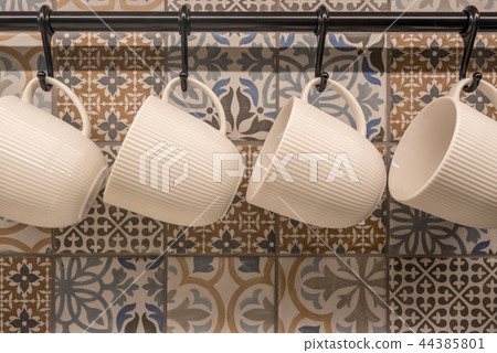 Ceramic cup hanging on stainless rail Ceramic cup hanging on stainless rail 44385801