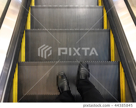 Businessman wore standing on the escalator. 44385845