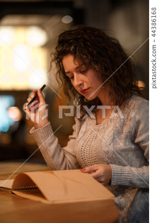 Cute blackhaired european woman in restraunt Cute blackhaired european woman in restraunt 44386168