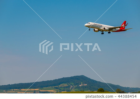 Helvetic Swiss airlines airplane preparing for landing at day time in international airport 44388454