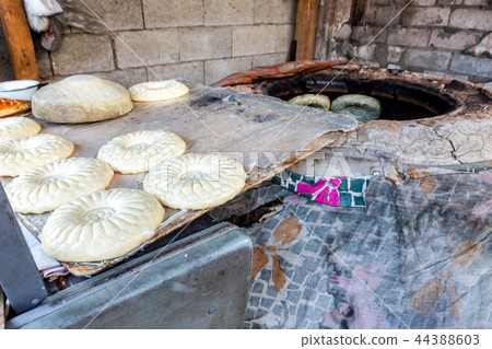 Uzbek flatbread is preparing to put in the tandyr Uzbek flatbread is preparing to put in the tandyr 44388603