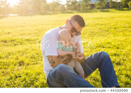Happy father holding baby son on nature. Concept of happy family, father's day and child. Happy father holding baby son on nature. Concept of happy family, father's day and child. 44388990