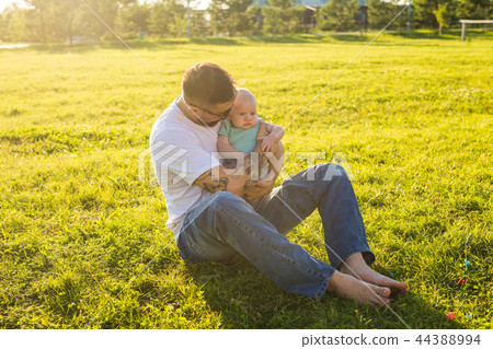 Happy father holding baby son on nature. Concept of happy family, father's day and child. 44388994