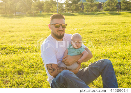 Happy father holding baby son on nature. Concept of happy family, father's day and child. Happy father holding baby son on nature. Concept of happy family, father's day and child. 44389014