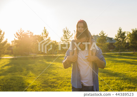 Fatherhood, family and children concept - Father and daughter having fun and playing in nature. Fatherhood, family and children concept - Father and daughter having fun and playing in nature. 44389523