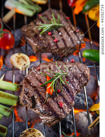 Barbecue grill with beef steaks, close-up. 44392734