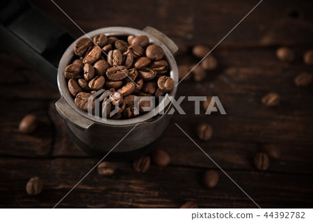 Fresh coffee beans in coffee maker. Fresh coffee beans in coffee maker. 44392782